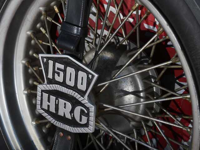 Image of an HRG spare wheel and strap with car badge. Image courtesy of Classic & Sports Car magazine.
